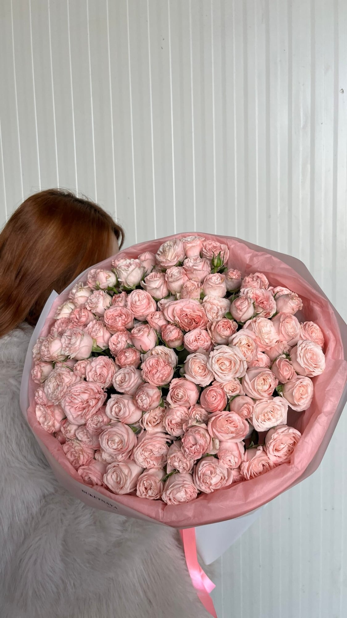 Bombastic Roses: A dense, round bouquet of pink Bombastic spray roses.